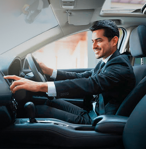 A right close up of a yellow Mercedes AMG sports car headlight on a city street